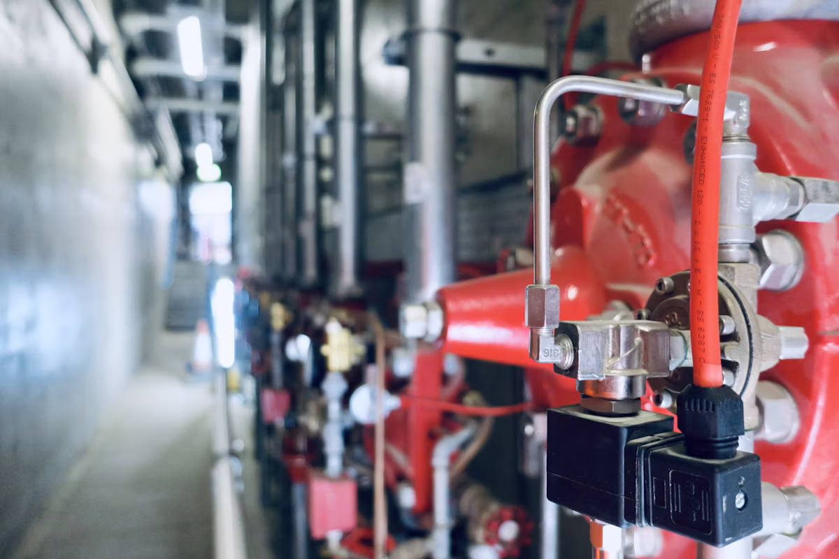 Close-up of industrial instrumentation and pressure gauges being checked
